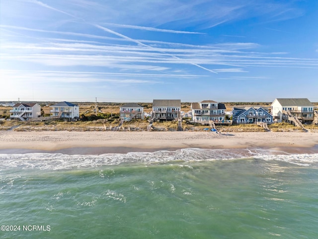 aerial view with a water view and a view of the beach