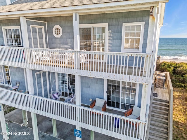 exterior space with a water view and a beach view