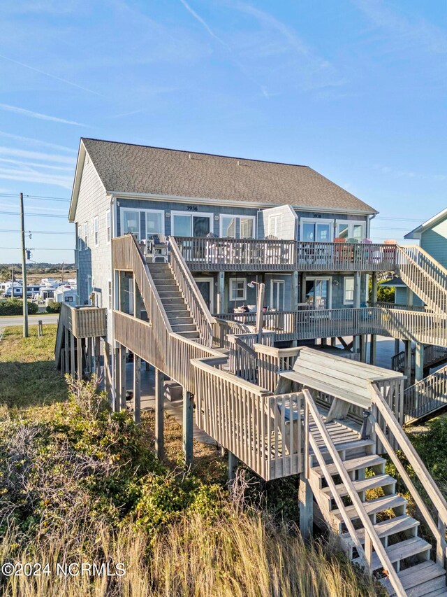 back of property with a wooden deck