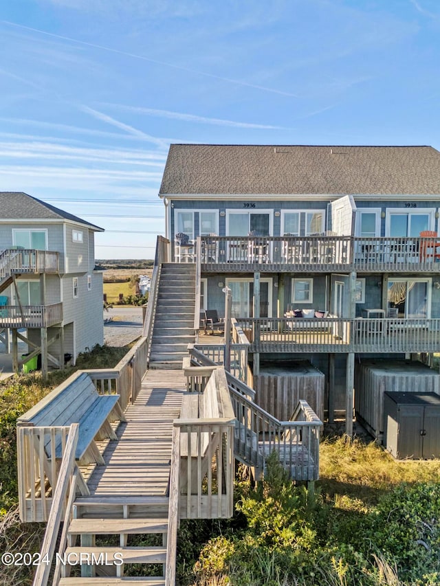 back of property featuring a wooden deck