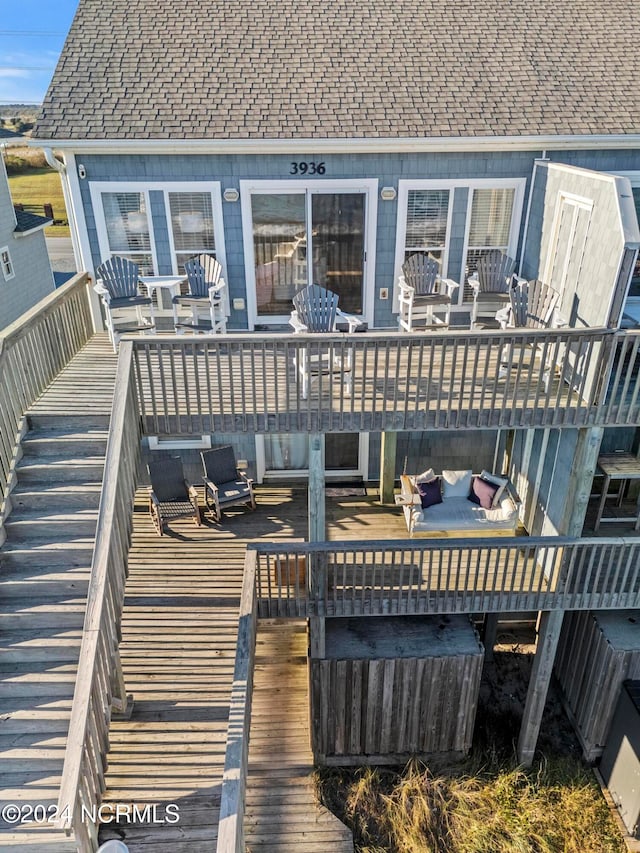 wooden deck with an outdoor living space