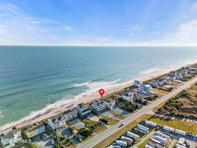 aerial view with a water view and a beach view