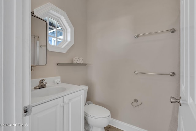 bathroom with vanity, toilet, and tile patterned flooring