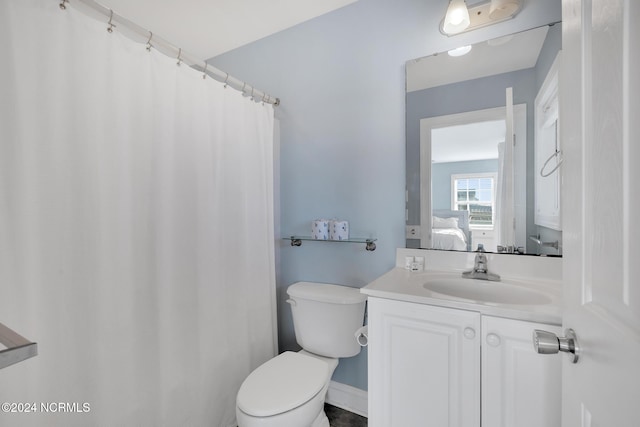 bathroom with toilet and vanity