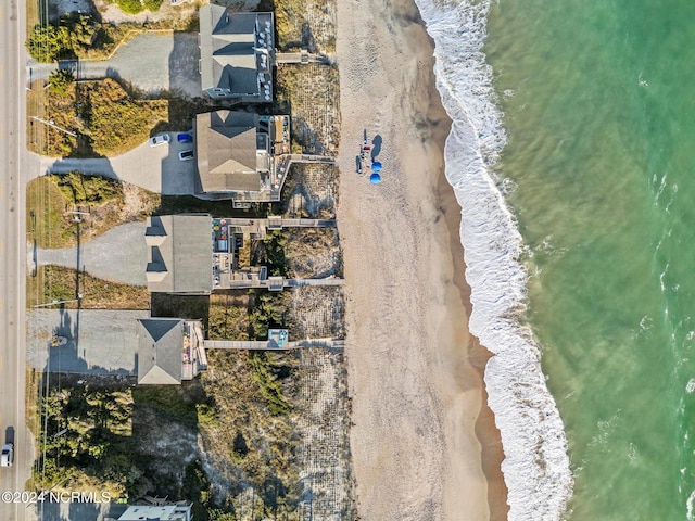 drone / aerial view with a water view and a beach view