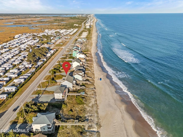 drone / aerial view featuring a water view and a beach view