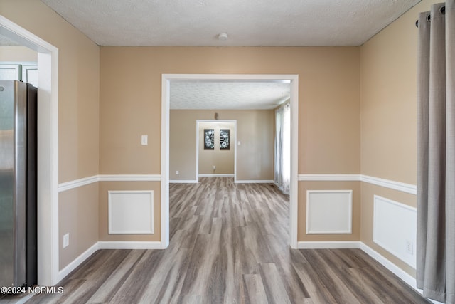 interior space featuring a textured ceiling and hardwood / wood-style flooring