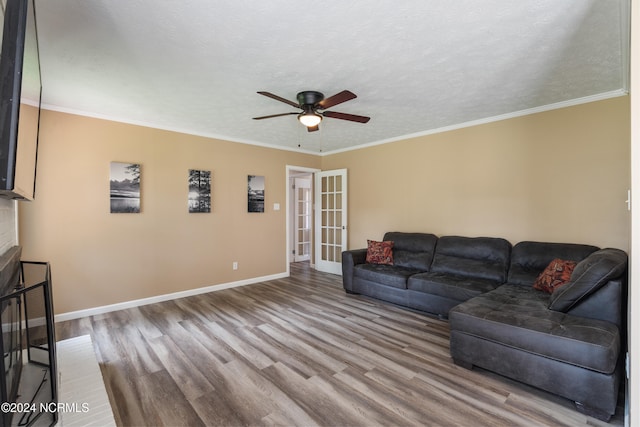 living room featuring ornamental molding, hardwood / wood-style floors, a textured ceiling, and ceiling fan