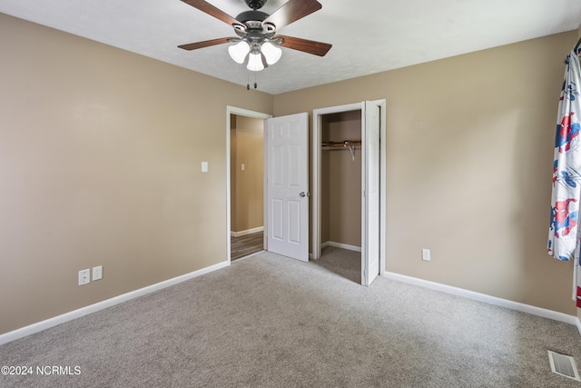 unfurnished bedroom with light colored carpet, a closet, and ceiling fan