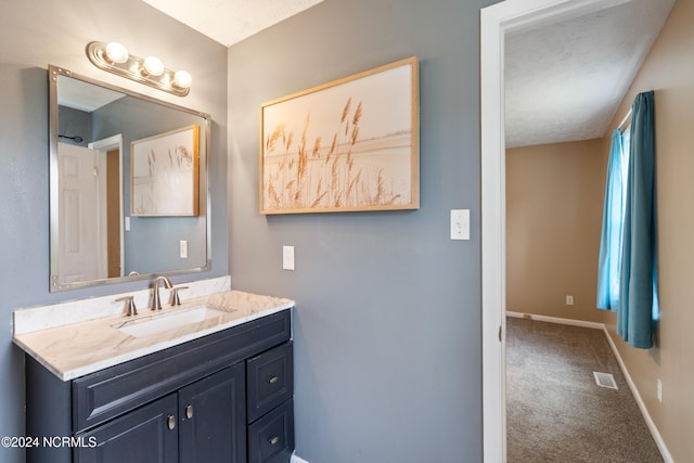 bathroom featuring vanity and a textured ceiling