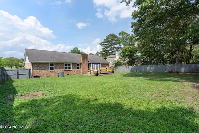 rear view of property featuring a yard