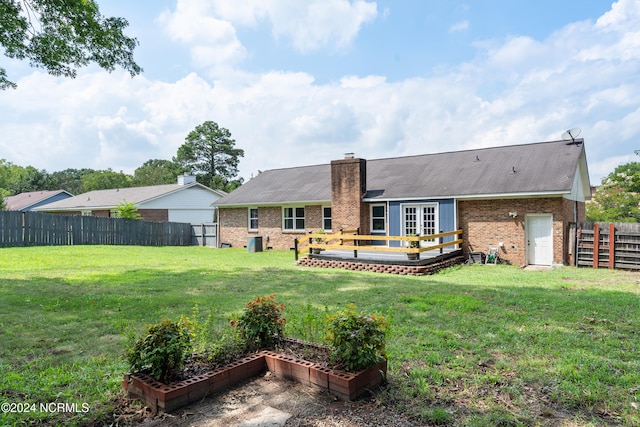 rear view of house featuring a yard