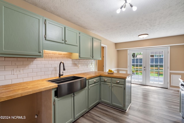 kitchen with french doors, butcher block counters, sink, and dark wood-type flooring