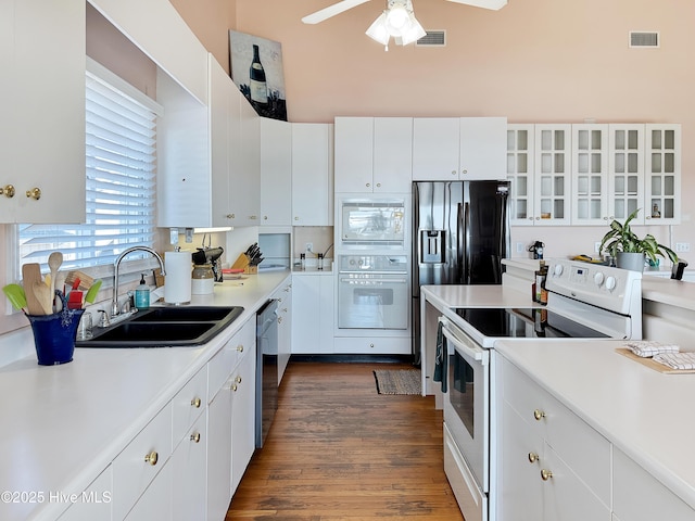 1324 Final Landing Ln, Wilmington, NC 28411 - kitchen with white appliances, light countertops, a ceiling fan, dark wood finished floors, and white cabinets