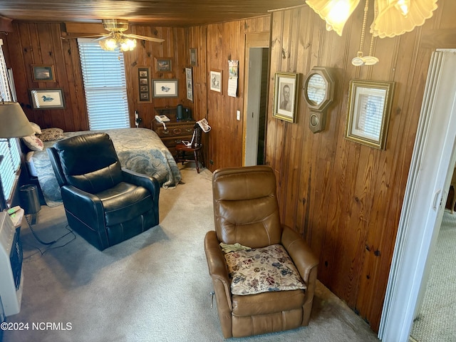 interior space with wooden walls and ceiling fan