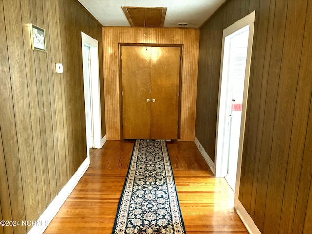 doorway to outside featuring wood walls and hardwood / wood-style floors