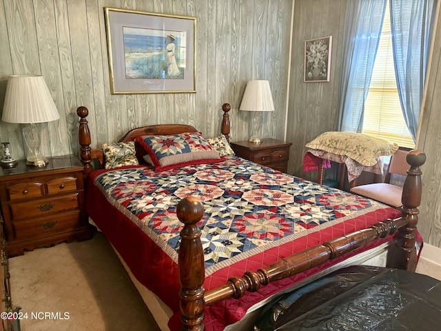 bedroom with wooden walls and carpet