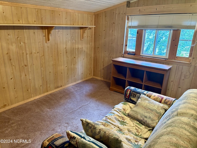 carpeted living room featuring wooden walls and wood ceiling