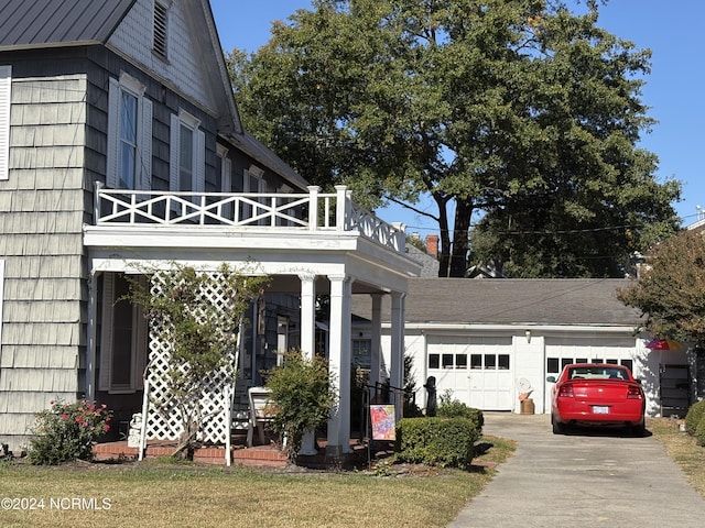 exterior space featuring a balcony and a garage