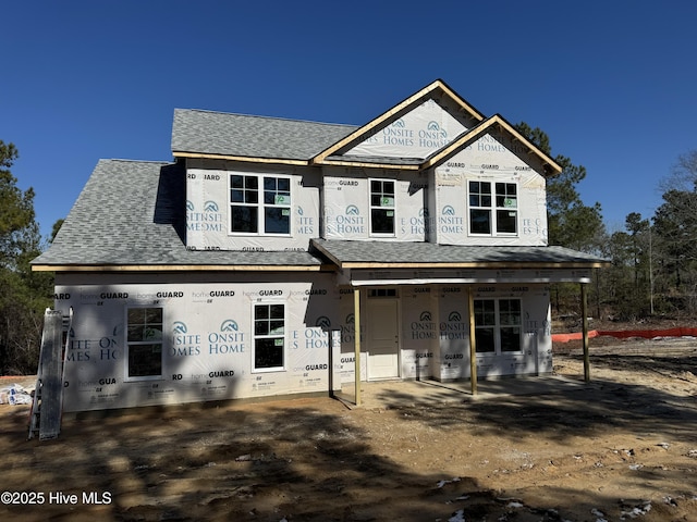 property in mid-construction featuring a shingled roof