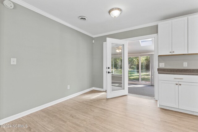 510 Millhouse Rd, Castle Hayne, NC 28429 - kitchen with light wood finished floors, ornamental molding, white cabinetry, and dark countertops
