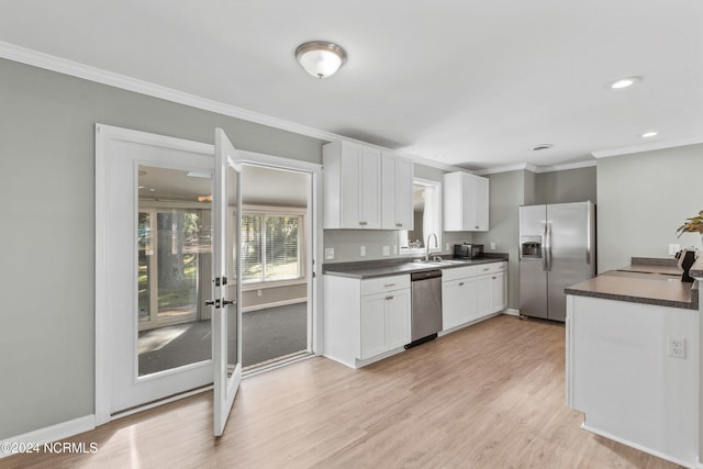 510 Millhouse Rd, Castle Hayne, NC 28429 - kitchen featuring dark countertops, white cabinetry, stainless steel appliances, and a sink