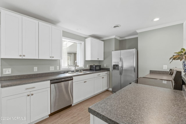 510 Millhouse Rd, Castle Hayne, NC 28429 - kitchen featuring a sink, appliances with stainless steel finishes, white cabinetry, light wood-style floors, and ornamental molding