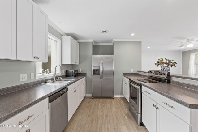 510 Millhouse Rd, Castle Hayne, NC 28429 - kitchen with a sink, stainless steel appliances, crown molding, white cabinets, and dark countertops