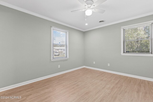 510 Millhouse Rd, Castle Hayne, NC 28429 - empty room featuring light wood finished floors, crown molding, baseboards, and a healthy amount of sunlight