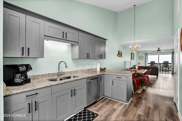 kitchen with dishwasher, wood-type flooring, sink, pendant lighting, and gray cabinets