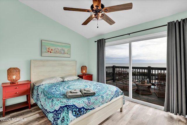 bedroom with ceiling fan, a water view, access to outside, and hardwood / wood-style flooring