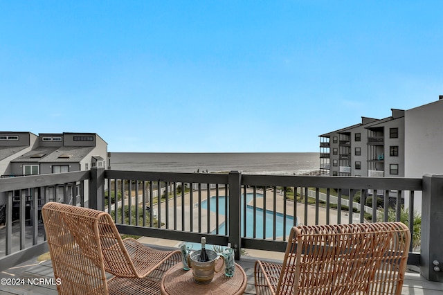 balcony with a water view and a beach view