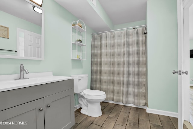 bathroom featuring vanity, toilet, hardwood / wood-style flooring, and a shower with curtain