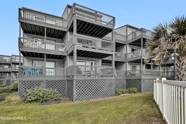 1928 New River Inlet Rd Unit 207, North Topsail Beach, NC 28460 - back of property with a balcony and a lawn