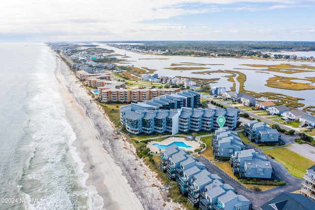 birds eye view of property featuring a water view and a beach view