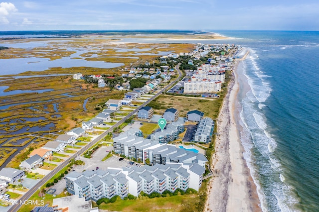 birds eye view of property with a water view and a view of the beach