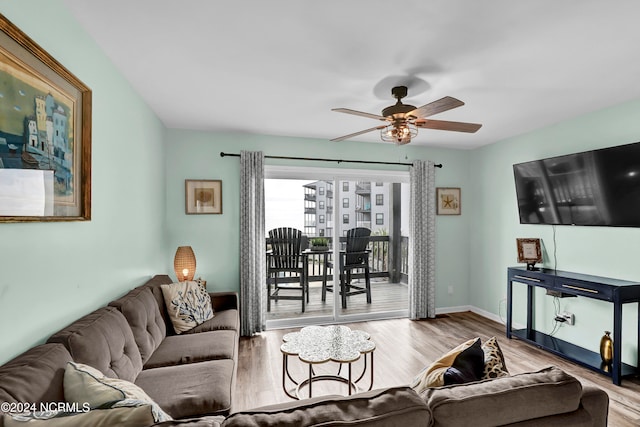 living room with light hardwood / wood-style floors and ceiling fan