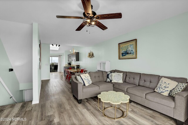 1928 New River Inlet Rd Unit 207, North Topsail Beach, NC 28460 - living room featuring a ceiling fan, wood finished floors, and a chandelier