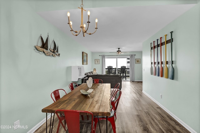 1928 New River Inlet Rd Unit 207, North Topsail Beach, NC 28460 - dining space with a chandelier, wood finished floors, baseboards, and a ceiling fan
