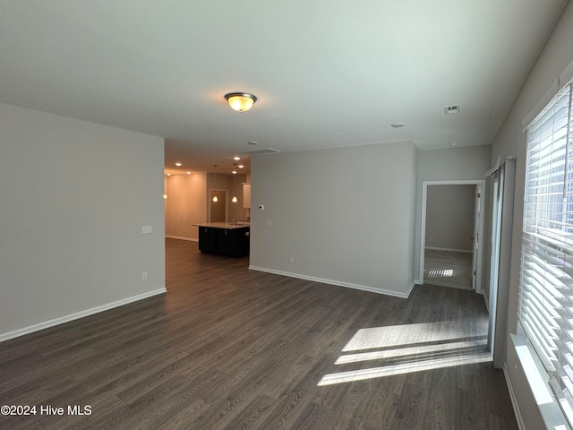 spare room with dark hardwood / wood-style flooring