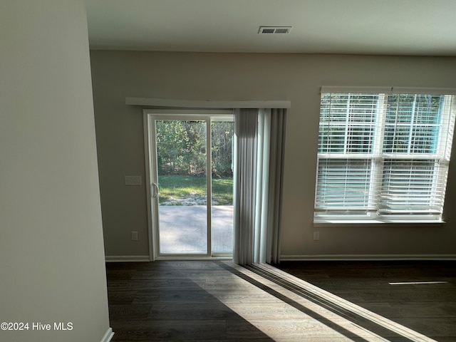 entryway with dark hardwood / wood-style flooring