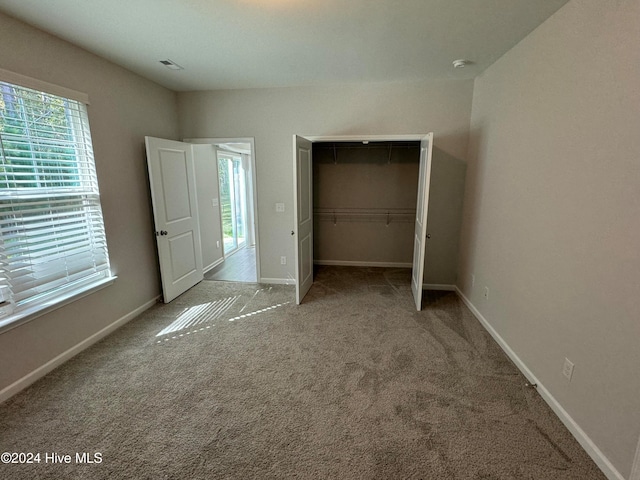 unfurnished bedroom with a closet and carpet