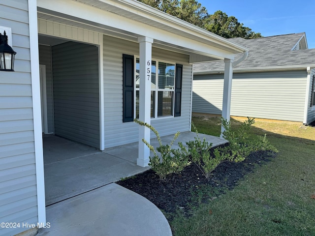 entrance to property featuring a lawn