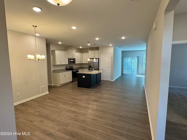 kitchen with white cabinets, hanging light fixtures, a kitchen island with sink, dark hardwood / wood-style floors, and stainless steel appliances