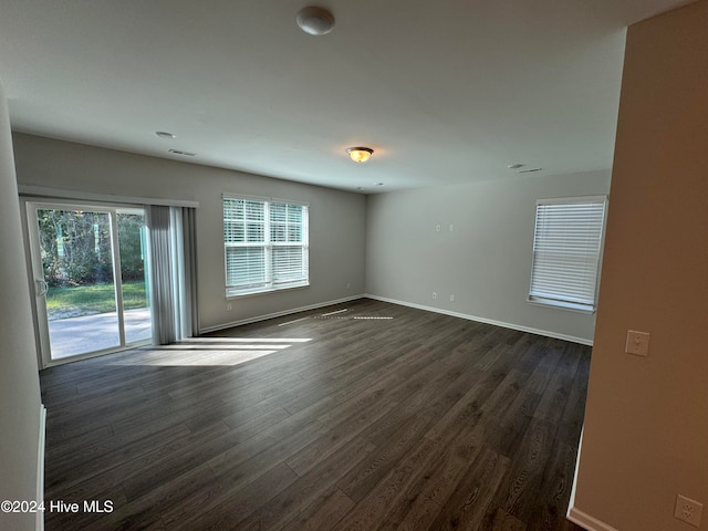 empty room with dark wood-type flooring