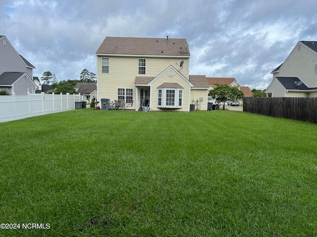 back of house featuring a yard