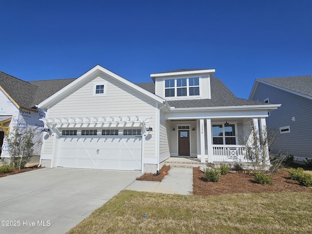 view of front of home featuring a garage, a porch, and a front yard