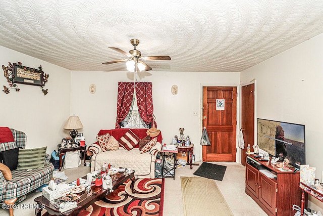 living room featuring a textured ceiling, light colored carpet, and ceiling fan