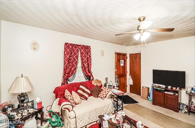 living room featuring light carpet, a textured ceiling, and ceiling fan