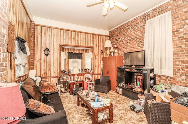 living room with wooden walls, brick wall, carpet, and ceiling fan